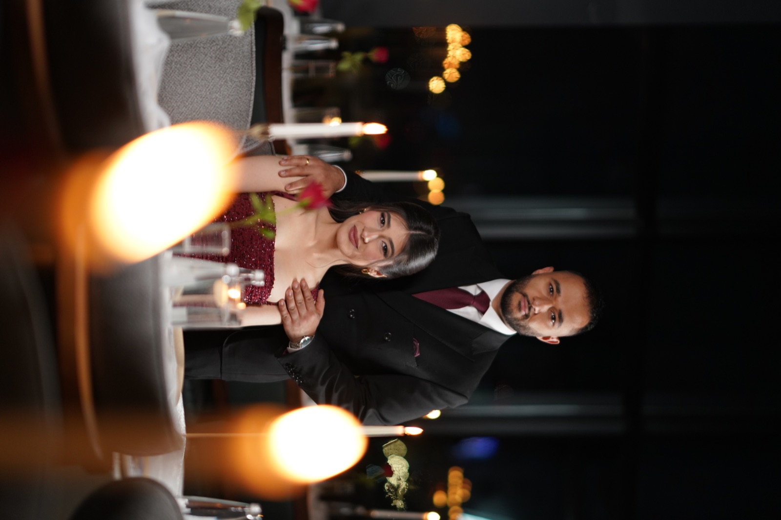Ninos and Ashurena at a candlelit formal dinner