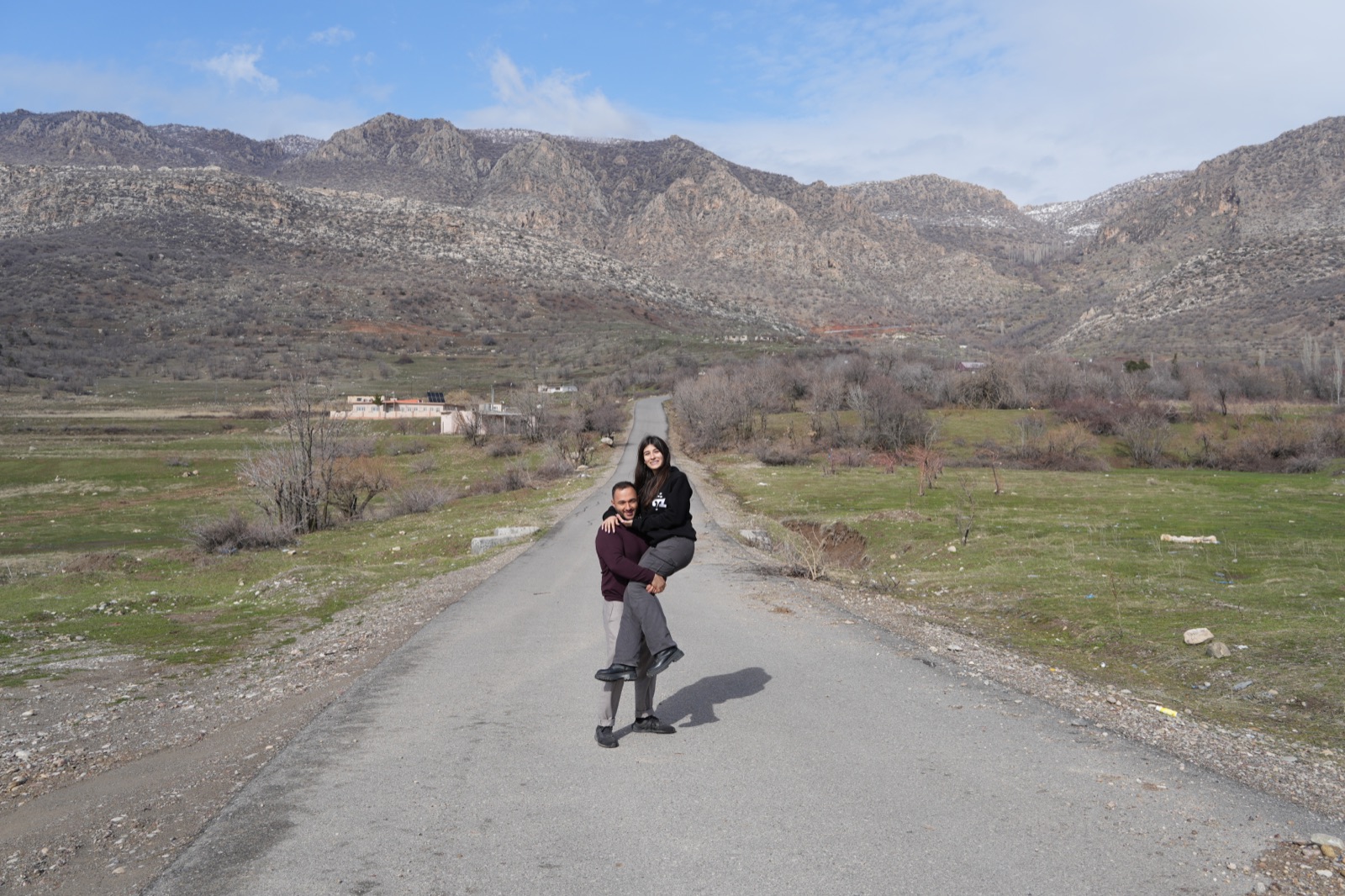 Ninos and Ashurena on the road to Araden, mountains behind