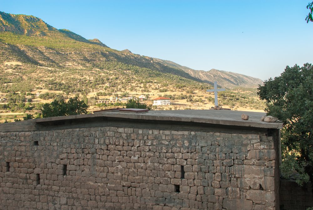 The exterior of Sultan Madokht Church with mountains behind